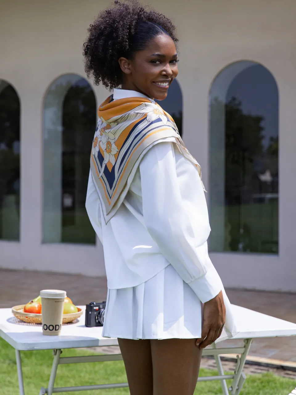 Narcissus & Swallows Silk Scarf-Orange/Navy — draped over the shoulders